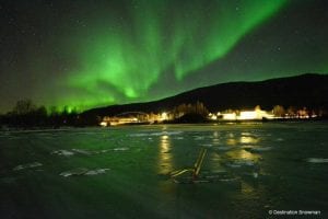 Nothern lights in darkness over ice Arctic Norway