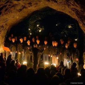 cave chorus men dark candles