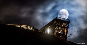Clarion The Edge Hotel in the dark behind a full moon in Tromsø town centre, Arctic Norway