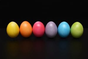 Multi coloured easter eggs with black backdrop stock photo