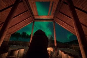 northern lights aurora borealis watching inside wood cabin