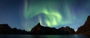 Northern Lights Aurora Borealis with mountain fjords in Reine Lofoten Norway