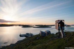 Arctic Hideaway in the summer with sunshine overlooking the lake of water