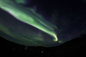 Northern rLights Aurora Borealis in the sky above a car