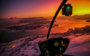 Midnight Sun in Tromso aerial view from a cockpit on a helicopter tour