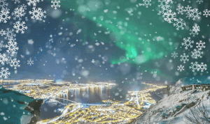 Snowflakes falling from the sky with Northern Lights over Tromsø