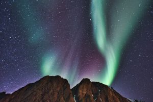 northern lights aurora over fjords and mountains